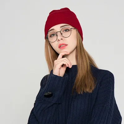 The new knitted woolen hat is thick and warm in solid color