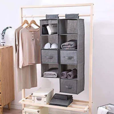 The linen cabinet contains hanging bags